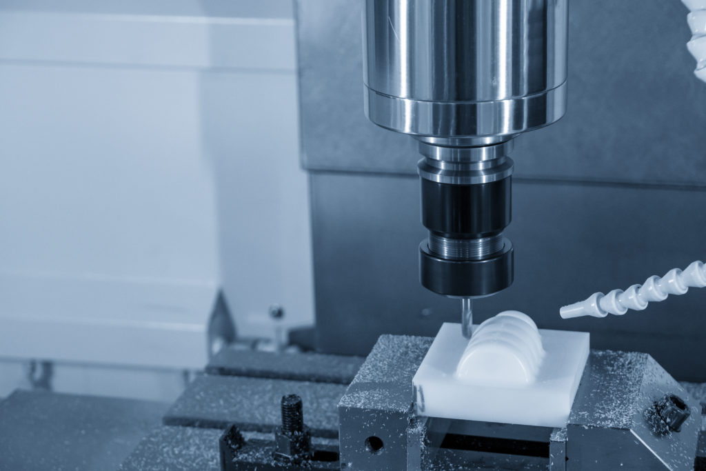 CNC machine making precision plastic components